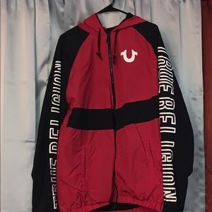 Red, black, and white True Religion windbreaker